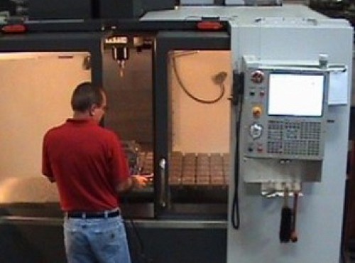 Employee creating extrusion dies using tool manufacturing