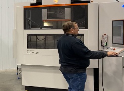 Employee creating streamlined extrusion die